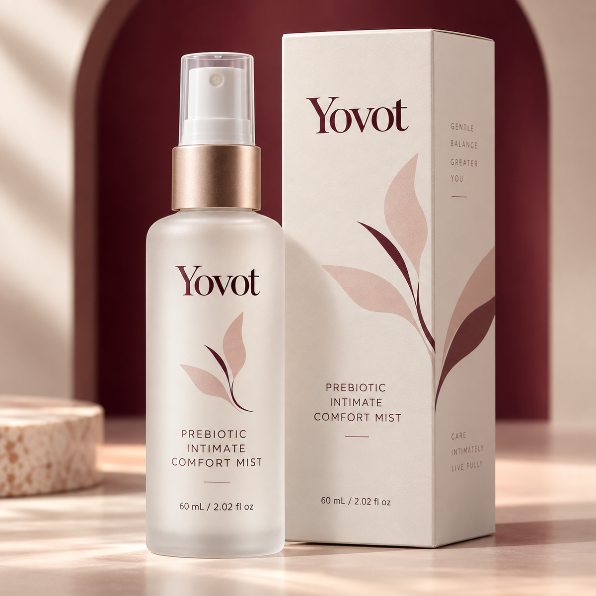 Yovot Prebiotic Intimate Comfort Mist bottle and carton in a premium burgundy and ivory studio